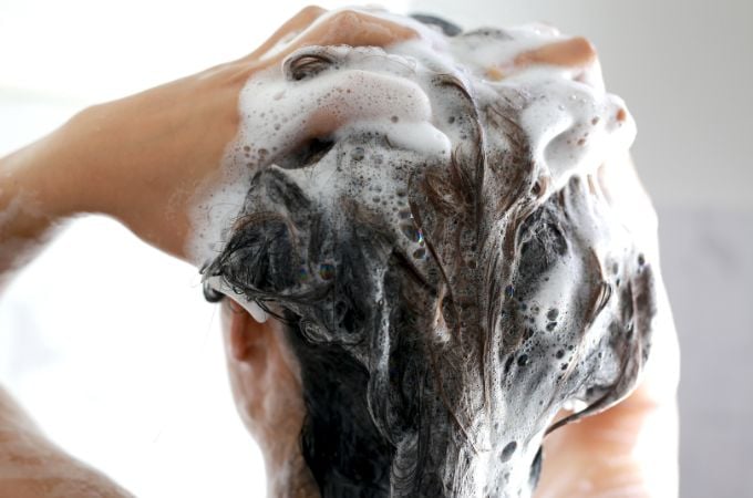 woman washing hair with shampoo